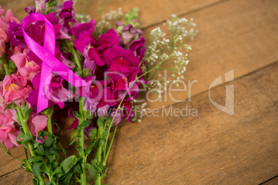 High angle view of pink Breast Cancer Awareness ribbon on flowers