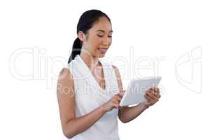 Smiling young businesswoman using digital tablet