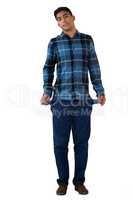 Full length of young man showing empty pockets