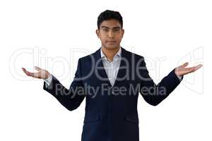 Portrait of young businessman gesturing while wearing suit
