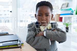 Portrait of businessman with arms crossed in office