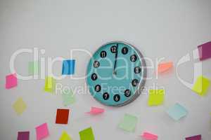Sticky notes with clock on wall