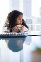 Businesswoman looking away while holding coffee cup at desk