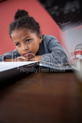 Close up of thoughtful businesswoman leaning on desk