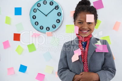 smiling businesswoman with adhesive notes stuck on suit and head