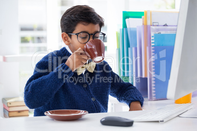 Businessman drinking coffee at desk