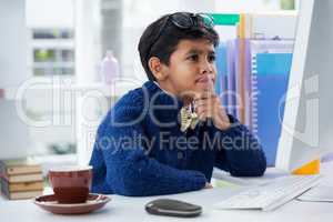 Confused businessman looking at computer monitor