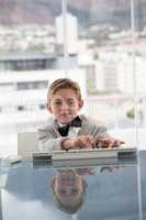 Portrait of businessman using keyboard at table