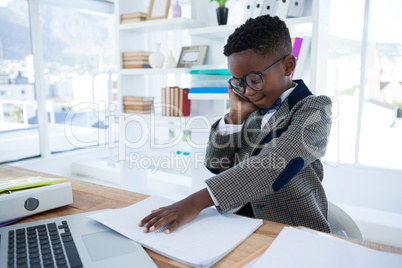 Smiling businessman talking on cellphone while looking at report