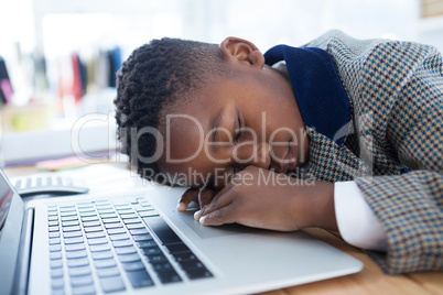 Businessman taking a nap on laptop