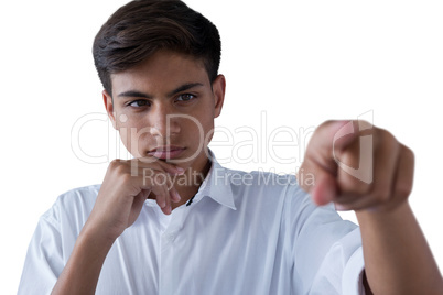 Teenage boy pressing an invisible virtual screen