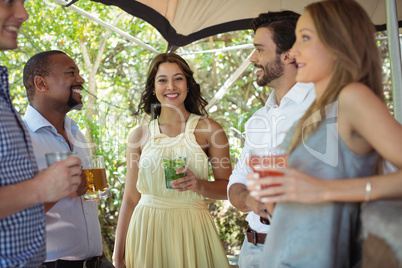 Friends interacting while having a alcohol at counter