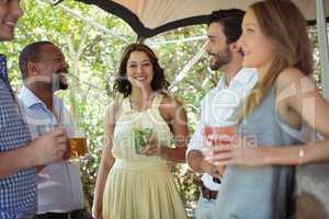 Friends interacting while having a alcohol at counter