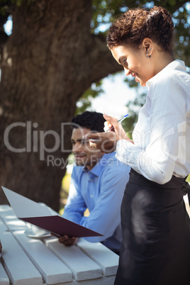 Waitress writing order on notepad