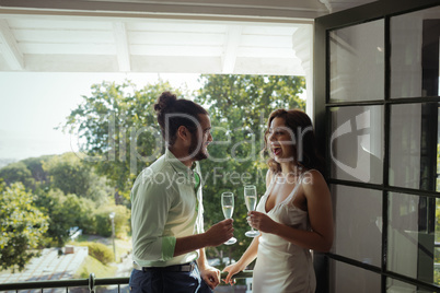 Couple interacting with each other while having champagne