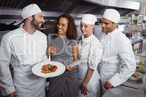 Restaurant manager interacting with his kitchen staff