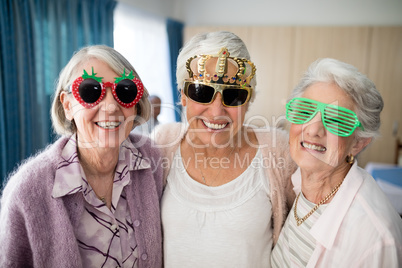 Portrait of smiling senior women wearing novelty glasses