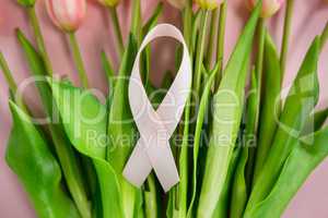 Close-up of Breast Cancer Awareness ribbon on tulip flowers