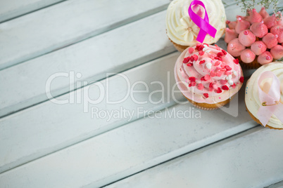 High angle view of Breast Cancer Awareness pink ribbons on cupcakes