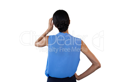 Rear view of businesswoman with head in hand
