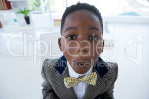 Close up portrait of boy imitating as businessman