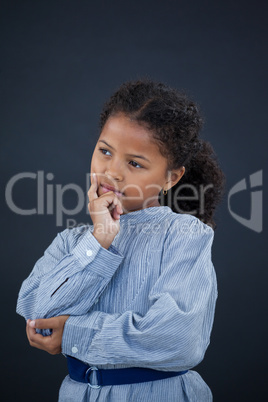 Thoughtful girl with hand on chin