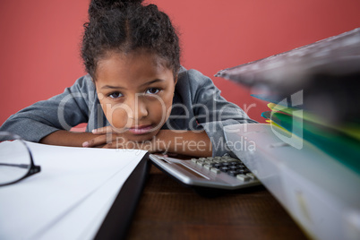 Close up portrait of girl pretending as businesswoman leaning on desk