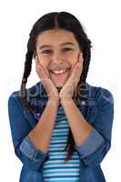 Smiling cute girl standing against white background