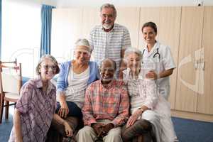 Portrait of confident doctor with senior people