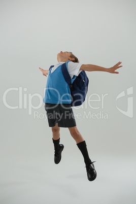 Schoolboy having fun against white background