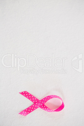 Overhead view of spotted pink Breast Cancer Awareness ribbon