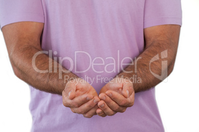 Mid section of man with hands cupped