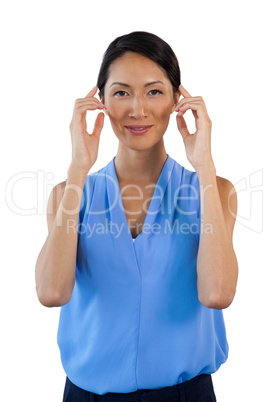 Portrait of smiling businesswoman adjusting imaginary eyeglasses