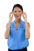 Portrait of smiling businesswoman adjusting imaginary eyeglasses