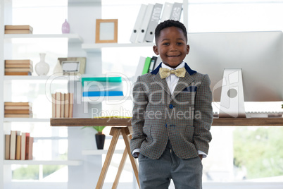 Portrait of boy imitating at businessman