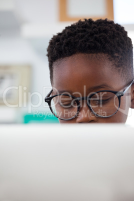 Close up of businessman wearing eyeglasses using computer