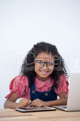 Portrait of smiling businesswoman with laptop and tablet computer