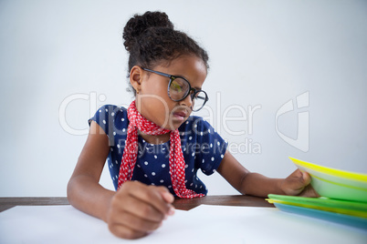 Girl as businesswoman looking at files on desk