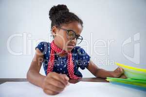 Girl as businesswoman looking at files on desk