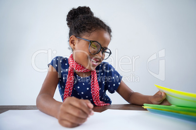 Smiling girl pretending as businesswoman reading documents