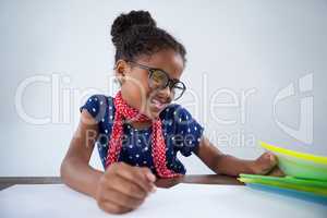 Smiling girl pretending as businesswoman reading documents