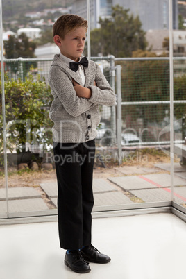 Businessman looking away while standing with arms crossed