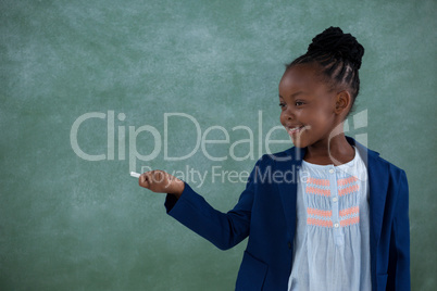 Businesswoman holding chalk and gesturing