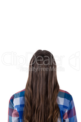 Teenage girl sitting against white background