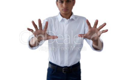 Teenage boy pressing an invisible virtual screen