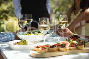 Close-up of food and wine glass on dining table