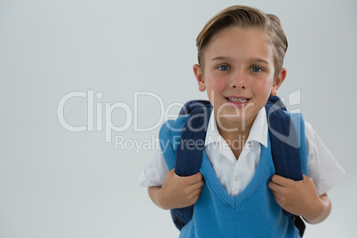 Smiling schoolboy looking at camera