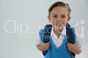 Smiling schoolboy looking at camera