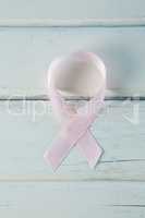 Overhead view of pink Breast Cancer Awareness ribbon on table
