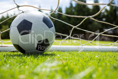 Close up of soccer ball in goal post